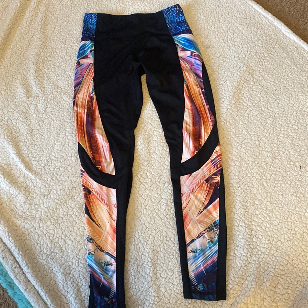 Orange Theory, black with multi-color down sides of the leggings. Medium.